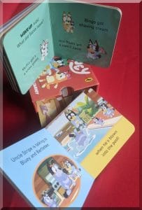 Inside pages of books form the box set of Bluey Christmas Little Library